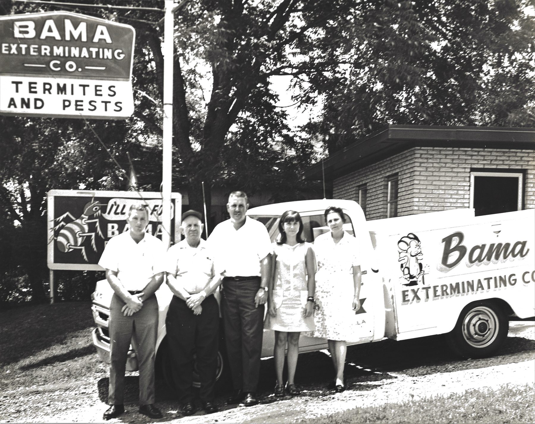 Bama Exterminating staff in front of an early office and truck