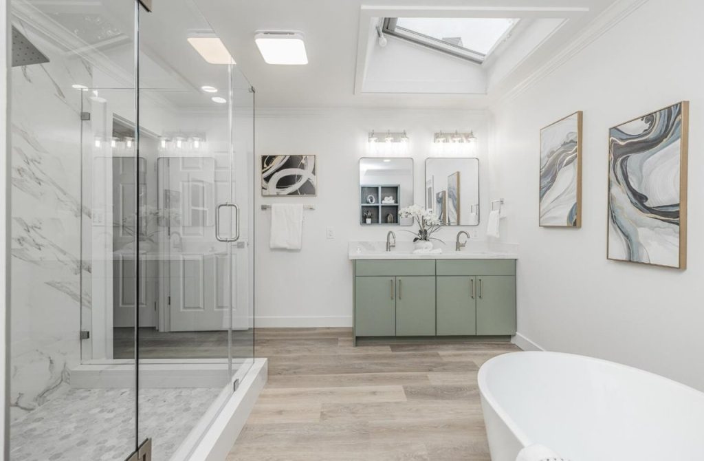La Casa San Ramon bathroom after the EPRE renovation, with a glass shower and freestanding tub