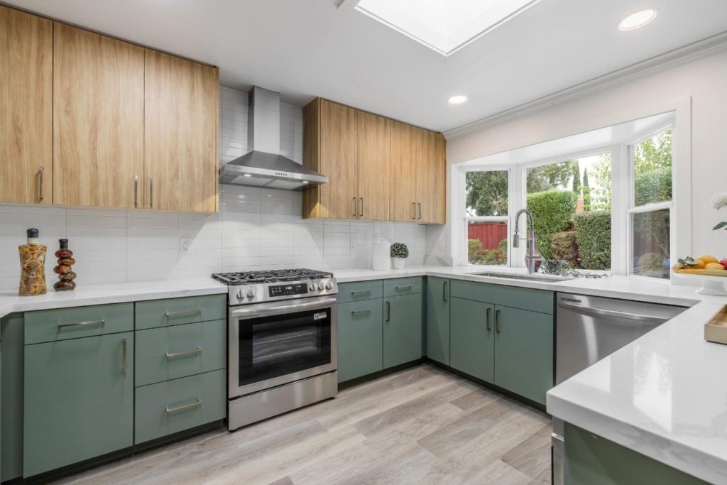 La Casa San Ramon kitchen after the EPRE renovation, with green cabinetry and a quartz island