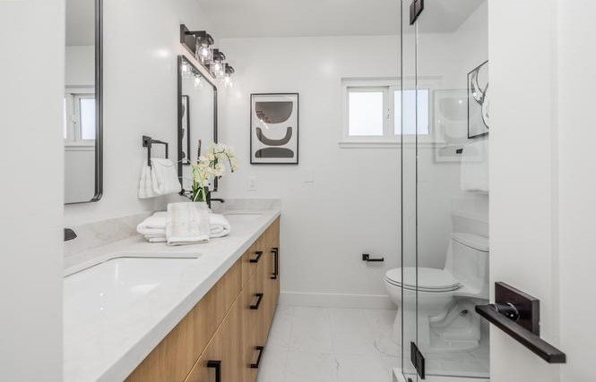 South Park Victoria Drive bathroom after the EPRE renovation, with a new vanity and walk-in shower